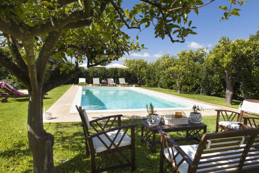 In the shade of a garden tree in the pool area in Casale dell'Ulivo Syracuse Scent of Sicily