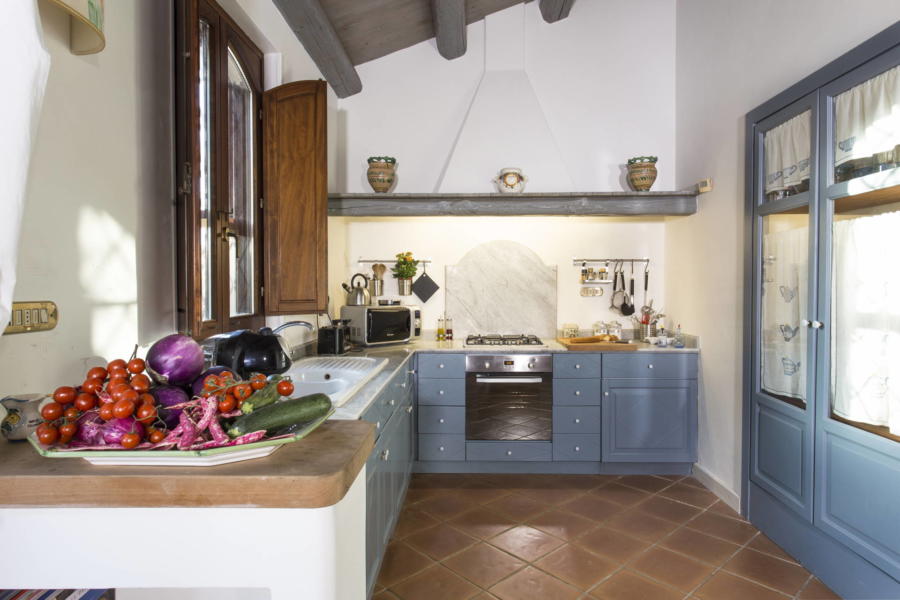 The kitchen overlooking the patio and the pool area inn Casale dell'Ulivo Syracuse Scent of Sicily