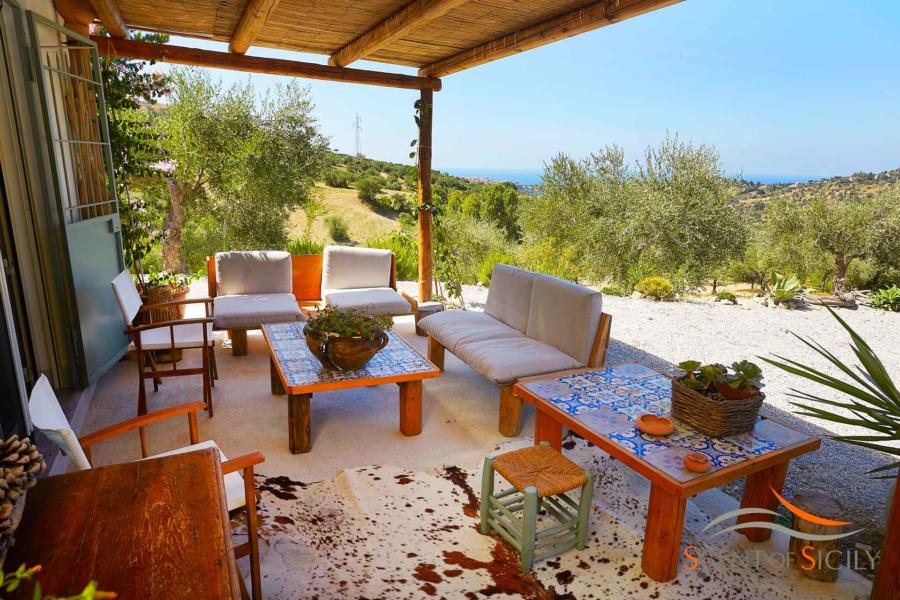 Comfortable sofa in the patio with a wonderful view in Villa Marina Scent of Sicily