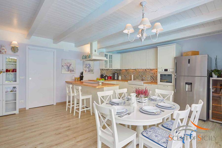 Well equipped kitchen with dining table in Villa Taormina Bellevue Taormina Scent of Sicily