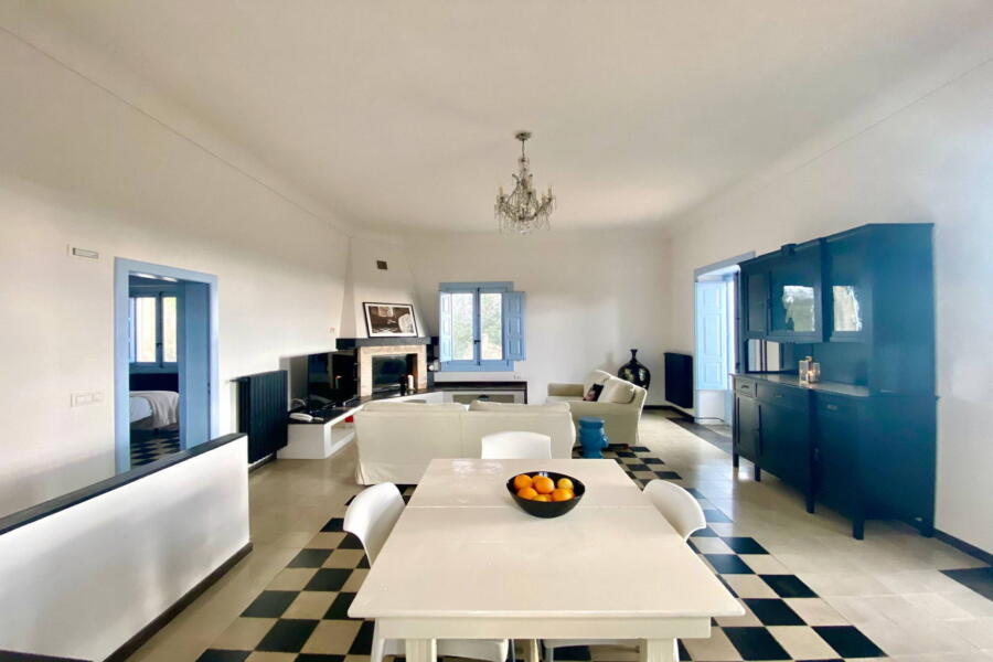 The dining area in the bright living room of the farmhouse