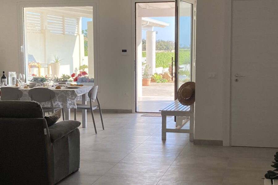 The living room on the ground floor directly overlooks the patio and swimming pool