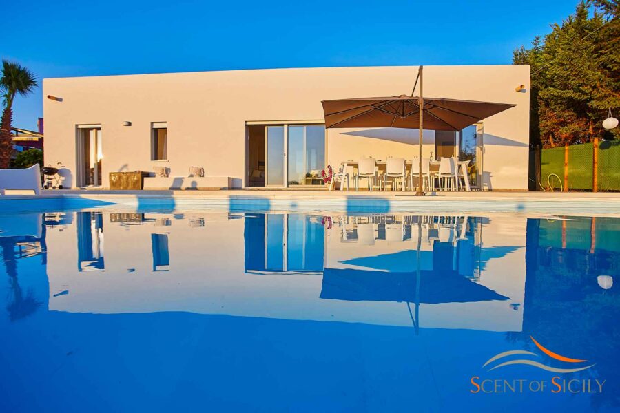 The view of the villa from the turquoise waters of the swimming pool