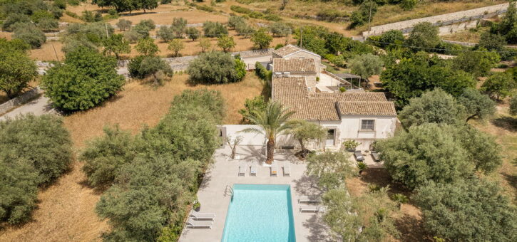 Aerial view of a Sicilian villa with pool surrounded by Baroque colors.