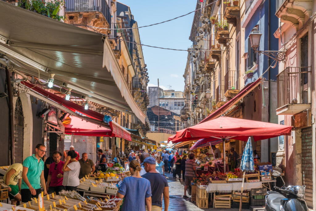 A lively Catania market scene during a radiant summer morning in Sicily, Southern Italy.