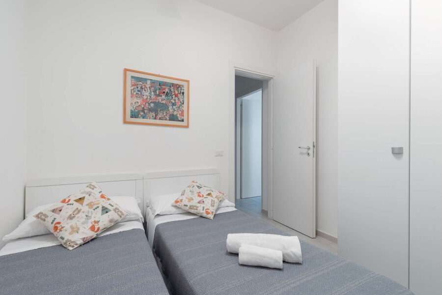 Twin bedroom with two single beds on the lower floor of a Sicilian villa.