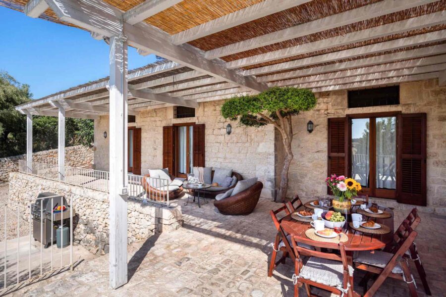 Sicily villa with pool - A picturesque patio with a tree at Villa Cudiano, Sicily.