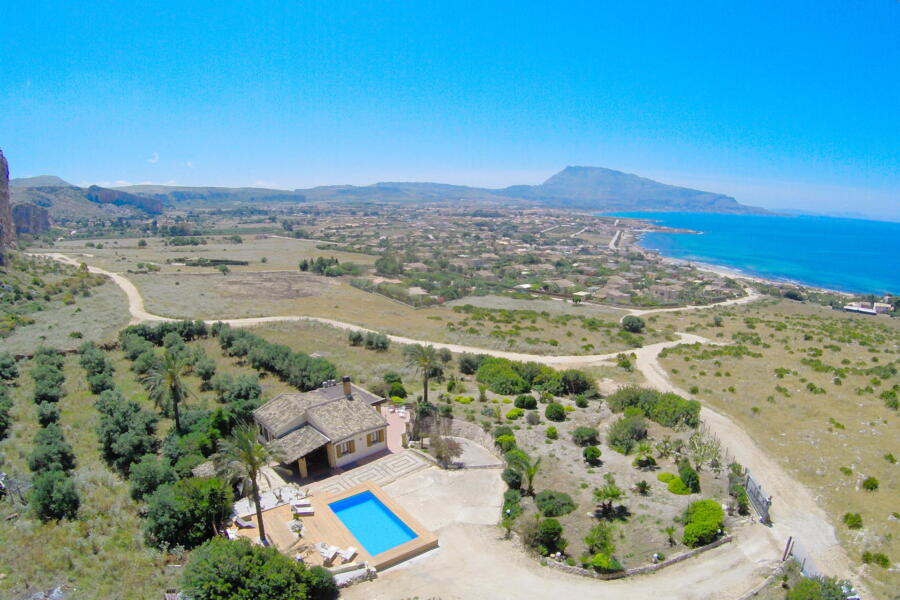 Aerial view of Villa Nature's Embrace with pool and surrounding terrain.