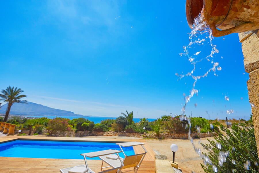 Water feature trickling by the pool at a luxury Sicilian villa.
