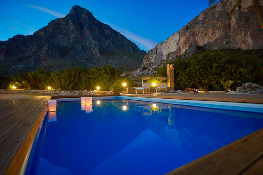 Evening view of a pool with mountain reflections at Villa Nature's Embrace.