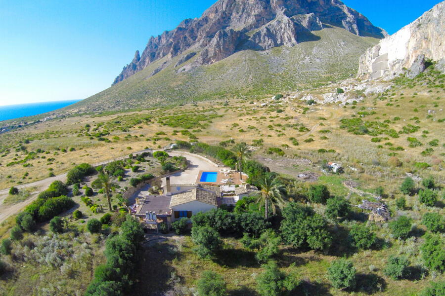 Aerial perspective of Villa Nature's Embrace in the Sicilian countryside.