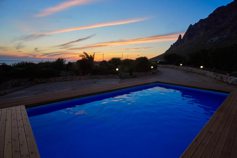Sunset sky with streaks of pink and blue over Villa Nature's Embrace's pool.