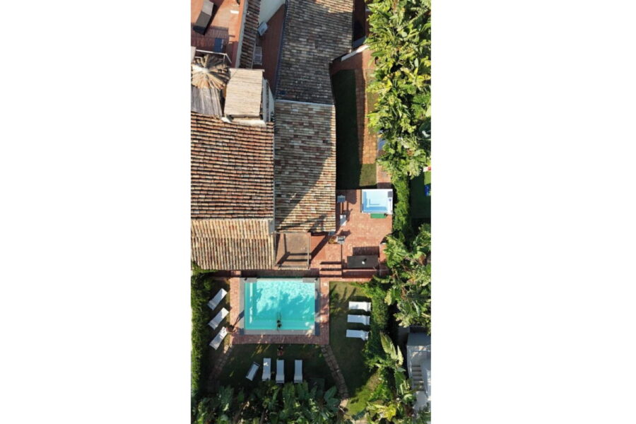 Aerial view of Villa Fontane Bianche in Siracusa, Sicily, showing a private pool, terracotta patio, sun loungers, and lush Mediterranean garden – ideal for Sicily villas with pool.