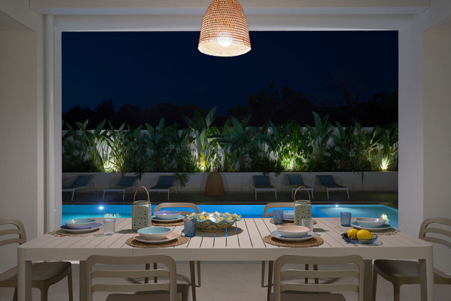 Sea Essence outdoor dining by illuminated pool at night in Pozzallo – Sicily Luxury Villas with pool