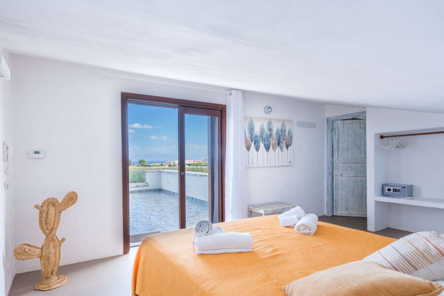 Double bedroom with private terrace and sea view at Villa Brezza Marina in Scopello featuring soft neutral décor and bright interiors – Sicily Luxury Villas and Sicily villas with pool