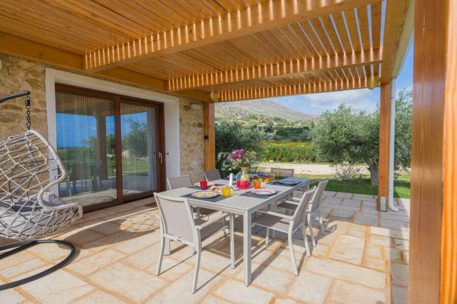 Outdoor dining terrace at Villa Brezza Marina in Scopello with wooden pergola, countryside and sea views, elegant table setting – Sicily Luxury Villas and Sicily villas with pool