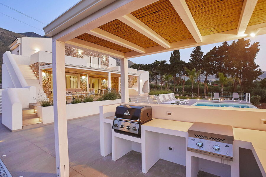 Sicily Villas – modern Sicily villa with pool and outdoor BBQ kitchen, covered terrace and lounge area at sunset in Castellammare del Golfo