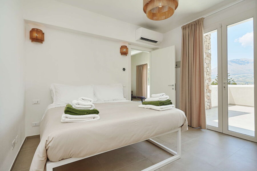 Elegant bedroom with terrace view in Sicily luxury villas with pool, featuring minimalist design and natural light at Villa White Horizon
