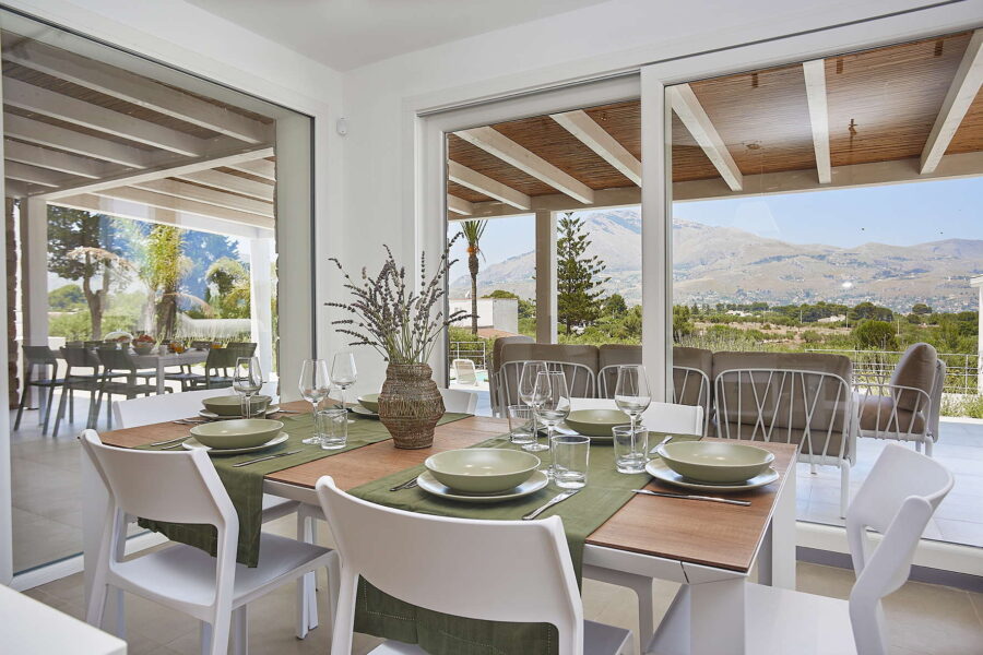 Indoor dining table with mountain view through large windows at Sicily Luxury Villas with pool, Villa White Horizon in Castellammare del Golfo