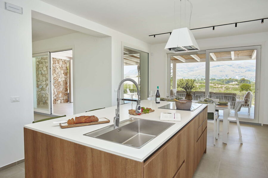 Open-plan kitchen with island, large windows and countryside views in Sicily Luxury Villas – Villa White Horizon, Sicily villas with pool