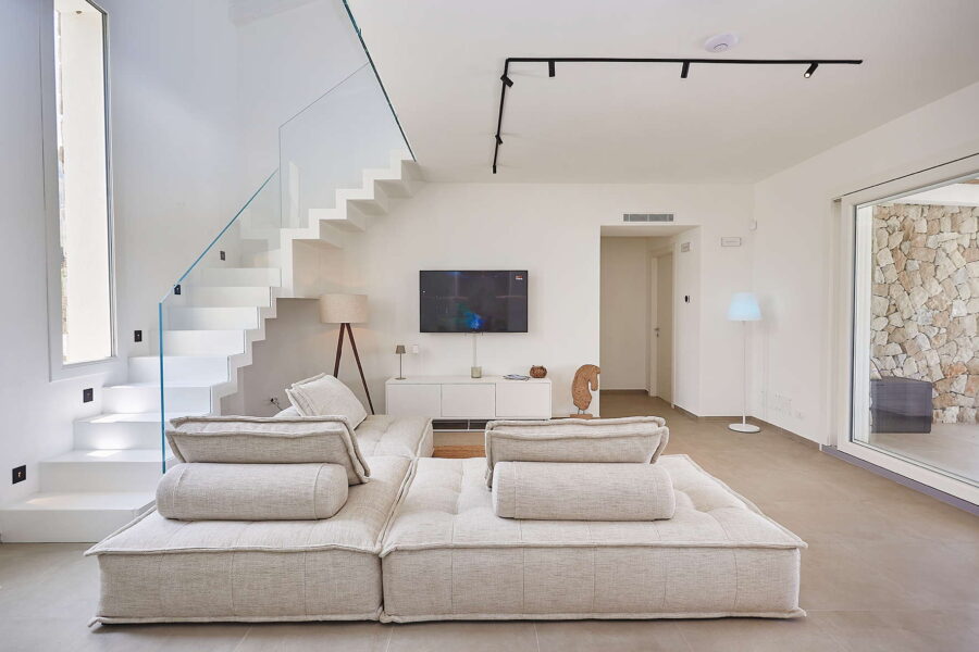 Bright living room with modern sofa, staircase and terrace doors in Sicily Luxury Villas – Villa White Horizon, Sicily villas with pool