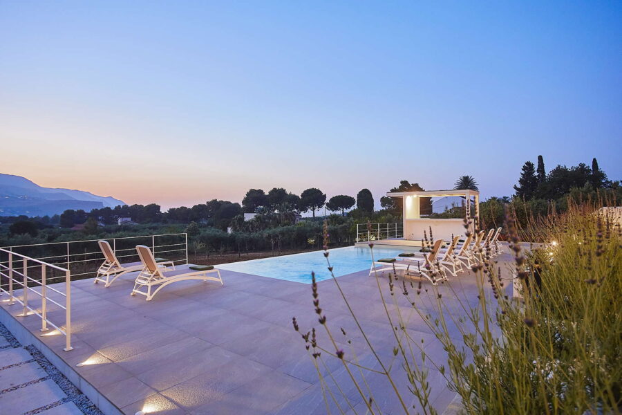 Sicily Luxury Villas with pool at sunset, modern terrace with loungers and infinity pool at Villa White Horizon in Castellammare del Golfo