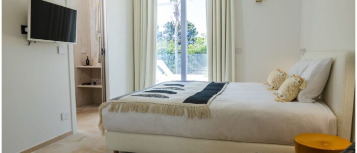 Elegant double bedroom suite at Villa Orlaya with modern interiors, en suite bathroom, and garden views in one of the finest Sicily villas with pool.