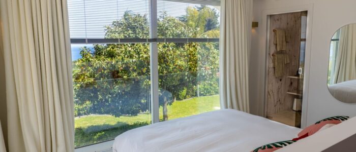 Bright double bedroom with en suite bathroom, garden and sea view at Villa Orlaya, one of the finest Sicily luxury villas with pool by Scent of Sicily.