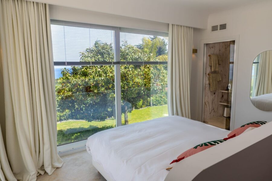 VillaOrlaya-Capo-di-Orlando-DoubleBedroomEnSuite-GardenSeaView-ScentOfSicily Bright double bedroom with en suite bathroom, garden and sea view at Villa Orlaya, one of the finest Sicily luxury villas with pool by Scent of Sicily.