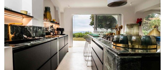 Villa Orlaya Designer Kitchen with Sea View | Sicily Luxury Villas Modern kitchen interior at Villa Orlaya with marble countertops, island, and sea view terrace, Sicily villas with pool by Scent of Sicily