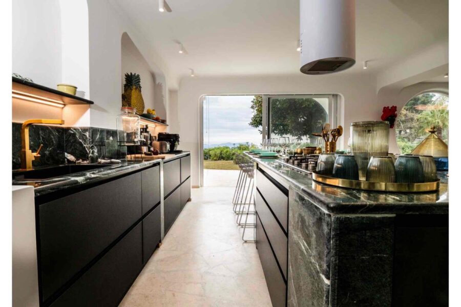 Villa Orlaya Designer Kitchen with Sea View | Sicily Luxury Villas Modern kitchen interior at Villa Orlaya with marble countertops, island, and sea view terrace, Sicily villas with pool by Scent of Sicily