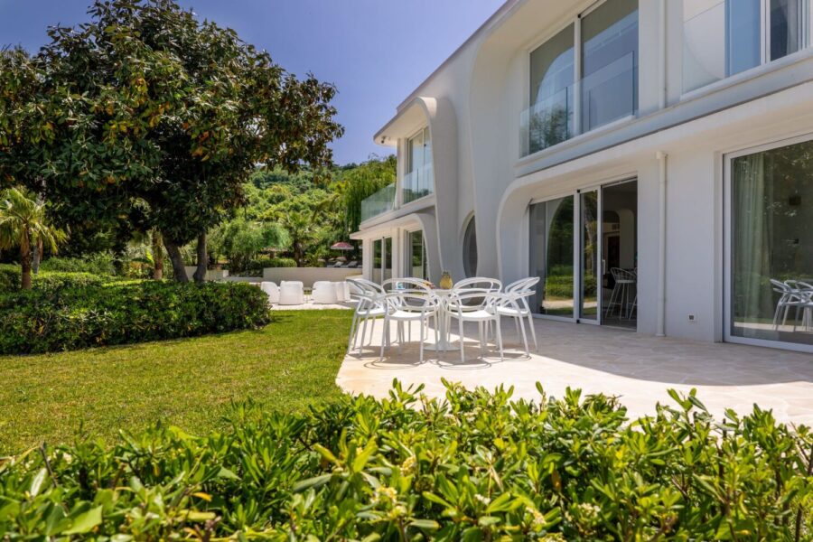 VillaOrlaya-Capo-di-Orlando-PatioTime-ScentOfSicily Villa Orlaya patio with outdoor dining area, garden views, and modern architecture in Sicily, Sicily villas with pool by Scent of Sicily