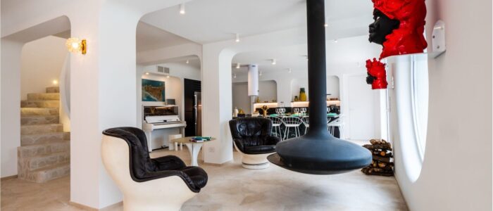 Modern living room with suspended fireplace and designer interiors at Villa Orlaya, a contemporary Sicily villa with pool and elegant open-plan spaces.