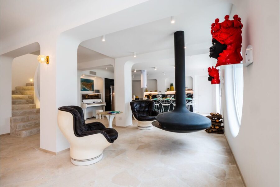 VillaOrlaya-Capo-di-Orlando-RelaxArea-ScentOfSicily Modern living room with suspended fireplace and designer interiors at Villa Orlaya, a contemporary Sicily villa with pool and elegant open-plan spaces.